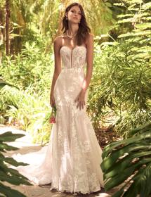 Model wearing a wedding dress in a jungle