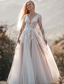 Smiling, radiant bride in the desert wearing Allure Romance R3708 wedding dress. Perhaps she is lost. 