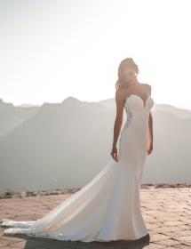 Women modeling a wedding dress by Allure Romance style A1214 in a desert with mountains in the background.