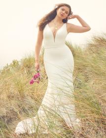Plus Size model wearing a wedding dress in a field of dreams.