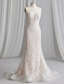 a wedding dress with much lace is on a mannequin
