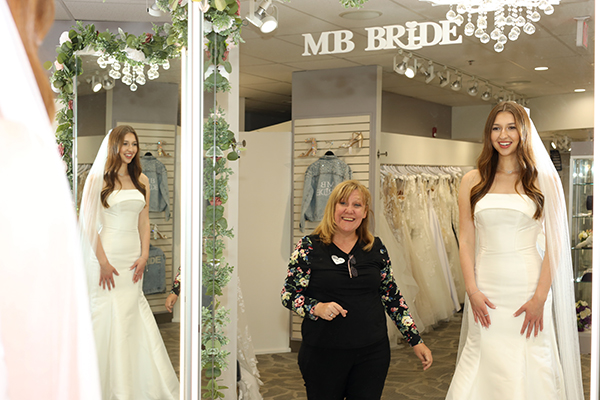 Image of a knowledgeable bridal stylist helping a Pittsburgh bride