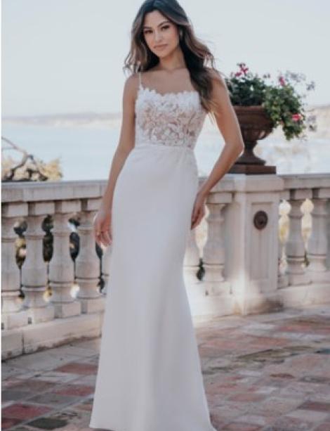 Beautiful model wearing a wedding dress in front of ornate pillars with a flower pot