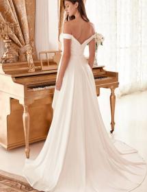 Model wearing a wedding dress in front of a piano.