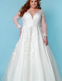 Plus size model wearing a beautiful wedding dress in front of a light blue background
