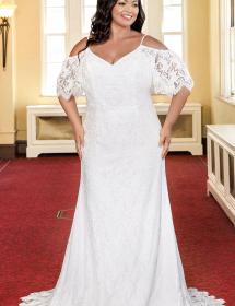 Plus size model wearing a beautiful wedding dress on a red carpet in an ornate room